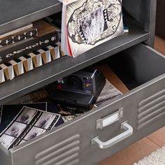 a metal filing cabinet filled with books and other items