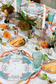 the table is set with plates, silverware, and other decorative items on it