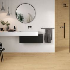 a bathroom with a sink, mirror and stool in the corner on the wall next to it