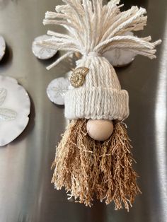 a close up of a stuffed animal wearing a knitted hat and pom - pom