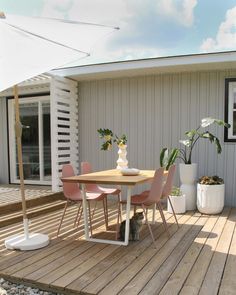 a table and some chairs on a wooden deck