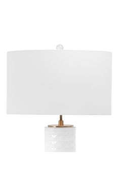 a white table lamp with a gold base