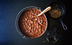 a pan filled with food next to two black dishes