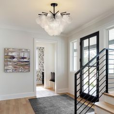 an entry way with stairs and chandelier