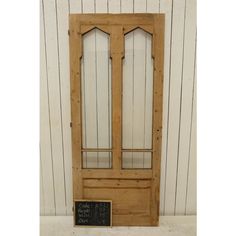 a wooden door with a chalkboard attached to the front and side panels on it