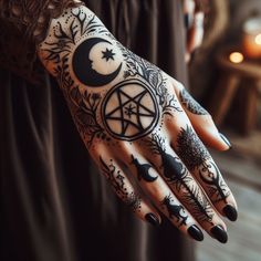 a woman's hand with tattoos on it and a pentagramil in the middle