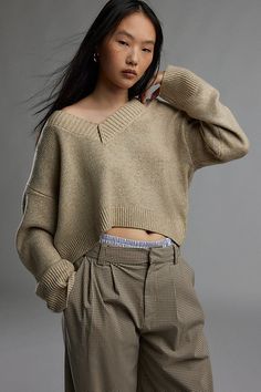 Forever staple BDG sweater in an effortless pull-over style. Designed in a boxy & cropped fit featuring a wide v-neckline and drop shoulders for a slouchy look. Finished with ribbed knit trim. Find it only at Urban Outfitters. Features BDG Jenna v neck sweater Slouchy sweater Soft and stretchy knit Wide v-neckline and long sleeves with ribbed knit trim Ribbed knit hem Boxy, relaxed fit Cropped length Easy pull-over style UO exclusive Contents + Care 53% Recycled polyester, 47% polyester Machine wash Imported Size + Fit Model in Black is 5'8" and wearing size Small Measurements taken from size Small Chest: 44" Length: 18" | BDG Jenna V-Neck Sweater in Tan, Women's at Urban Outfitters Bdg Sweater, Slouchy Sweater, Small Chest, V Neck Sweater, Find It, Vneck Sweater, Neck Sweater, Ribbed Knit, Urban Outfitters