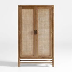 an armoire with two doors and wickers on the front, against a white background