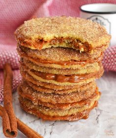 cinnamon sugar cookies stacked on top of each other with cinnamon sticks next to the stack