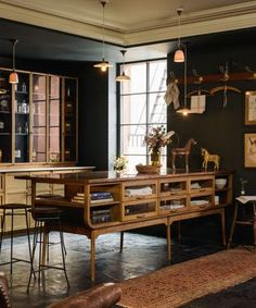 a living room filled with furniture and lots of windows