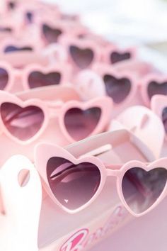 pink heart shaped sunglasses sitting on top of a table