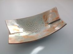 a large metal dish sitting on top of a table