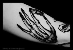 a black and white photo of a hand with knives on it's left arm