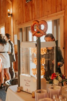 a table topped with donuts and drinks on top of a white tablecloth covered table