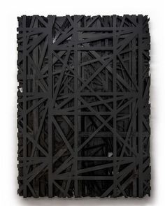 an abstract piece of art made out of black wood