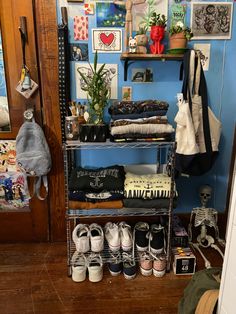 there is a shelf with shoes and other items on it in the room next to a door