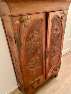 an old wooden cabinet with carvings on the doors