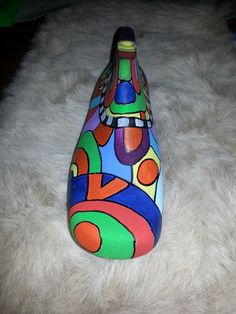 a colorful vase sitting on top of a white rug