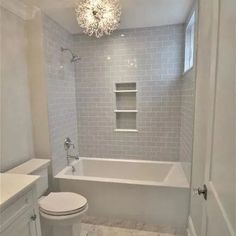 the bathroom is white and has gray tile on the walls, floor, and ceiling