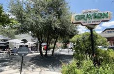 an outdoor restaurant with tables and umbrellas