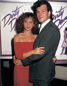 a man and woman standing next to each other in front of a sign that says dirty pants