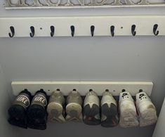 there are many pairs of shoes hanging on the wall