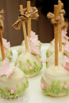 small cake pops decorated with pink and green decorations