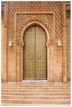 an ornate doorway with steps leading up to it