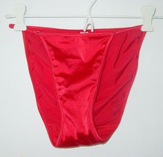 New Vintage Victoria's Secret red satin stretch string bikini undie. These are similar to the second skin satin but I've never seen a pair with the little silver rectangles like these have connecting straps in front therefore I'm not going to call them that to be on the safe side. Waist measures 23" around unstretched. Rise is 9 3/4" high laying flat. Size large. 70% nylon and 30% lycra spandex. Tags intact in items.(inv321) A very few blemishes on fabric due to shininess of fabric and normal st Transgender Outfits, Lingerie Photos, Women's Shapewear, Bra And Panty Sets, Red Satin, Second Skin, New Vintage, Women Lingerie, String Bikinis