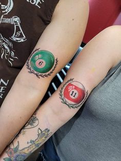 two people with tattoos on their arms and one has a pool ball tattooed on the arm