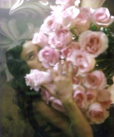 a woman holding flowers in front of her face