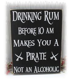 a sign that says drinking rum before 10 am makes you a pirate not an alcoholic