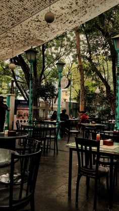 an outdoor dining area with tables and chairs