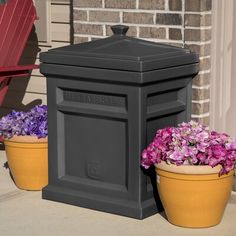 two flower pots are next to a mailbox