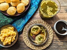 some food is sitting on a table with two cups and sauces next to it