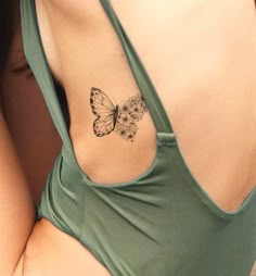 a woman with a butterfly tattoo on her back