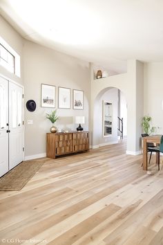 a living room with hard wood floors and white walls