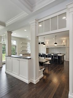 an open kitchen and dining room with hardwood floors