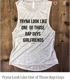 a tank top that says, try look like one of those rap guys girlfriendss