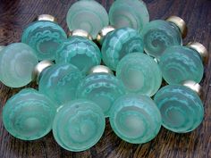 several green glass bowls sitting on top of a wooden table