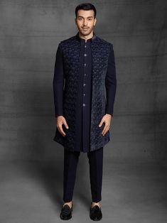 Make a statement adorning this front-opening, hand-crafted indo-wester. This designer Indo-western for the groom is designed with an outer sherwani-style sleeveless jacket made from the finest Italian embroidered cloth. It may be tailored to your exact measurements, and the resulting garment will look and feel fantastic on you. The sherwani and the rest of the outfit are covered in exquisite hand embroidery and zari. Note: Some colour variations may occur owing to photography causes. Up to 1 inch of measurement fluctuation is possible. NOTE: COST INCLUDED OUTSIDE JACKET ,TROUSER & INSIDE SHERWANI AS IN THE PICTURE Groom Dress For Wedding, Western Outfits For Men, Sleeveless Jacket For Men, Unique Mens Wedding Suits, Indo Western Outfits For Men, Indo Western Dress For Men, Men Wedding Dress, Wedding Dress Groom