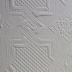 a close up view of an intricate white wallpaper