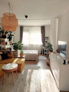 a living room filled with furniture and a flat screen tv