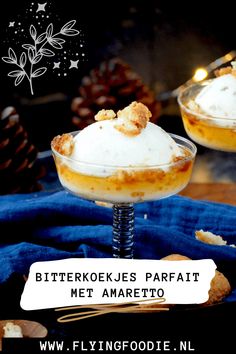 two desserts with whipped cream on top are sitting on a blue cloth and there is a sign that says, bitterkoke jes parfait met amareto