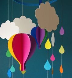 colorful hot air balloons floating in the sky with clouds and raindrops hanging from them