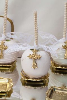 some white and gold decorated desserts on a table