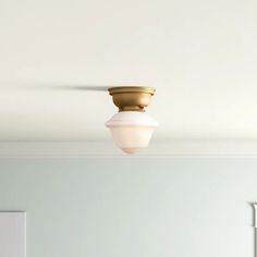 a white ceiling with a light fixture in the middle and a mirror on the other side