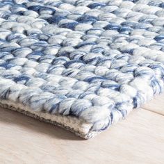 a blue and white rug is laying on the floor