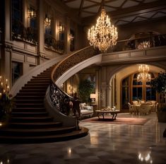 a large foyer with chandelier, couches and tables in the middle of it