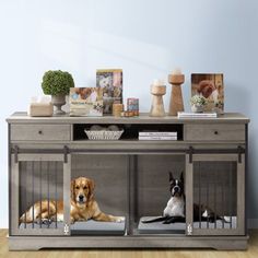 two dogs sitting in their kennels on the floor next to a table with food